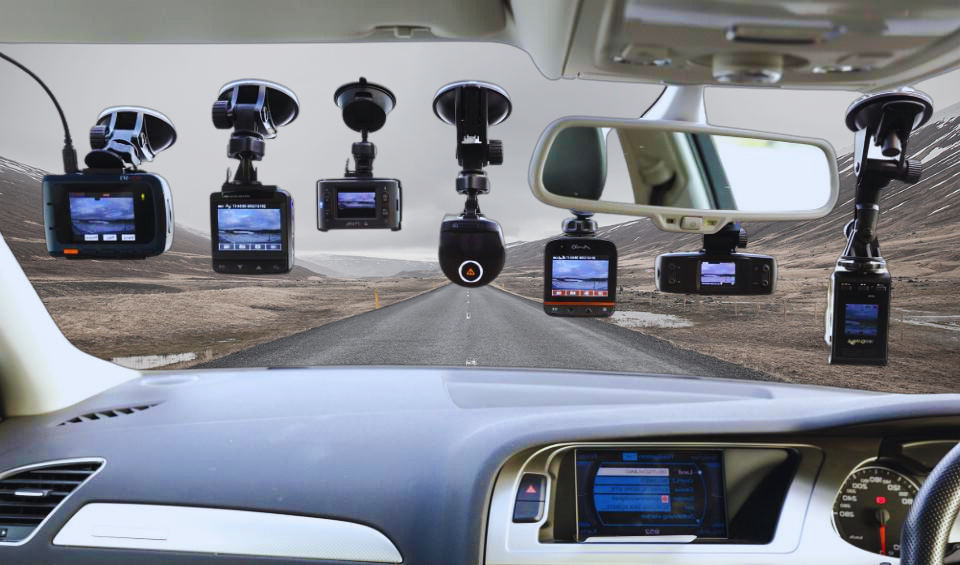 Several different dash cam models shown above a car dashboard with an open road ahead through the windshield