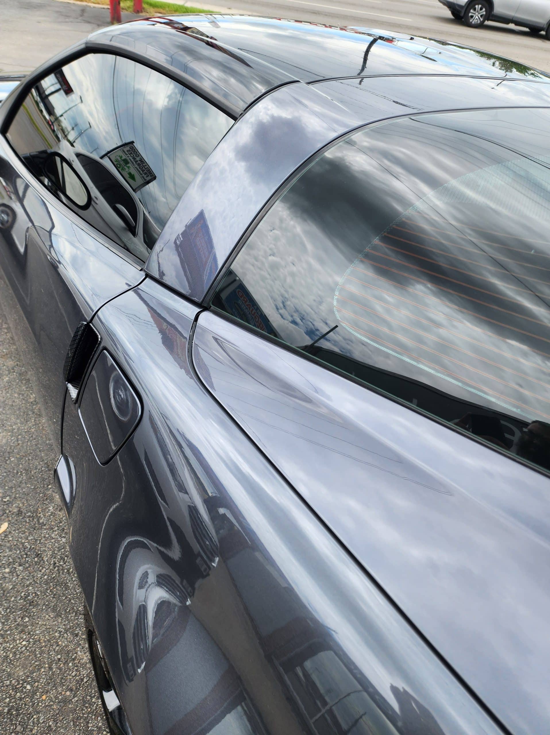 Overhead view of a gray sports coupe with dark tinted side and rear windows.